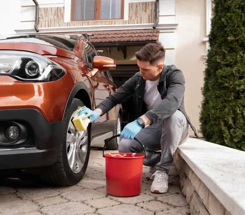 Lavage auto à domicile La Ferté-en-Ouche : professionnel intervenant sur un véhicule
